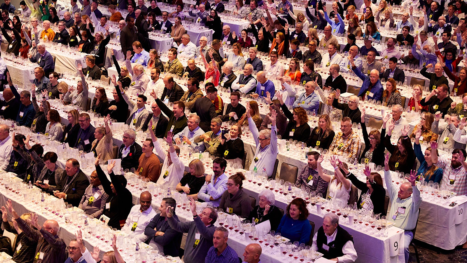 The audience of New York Wine Experience voting for their favorite pairing, some with both hands.